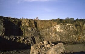 Quarry at Champagnac showing layers of breccia and rock formed affter the meteorite impact